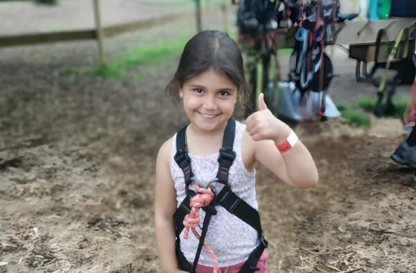 Young girl in harness about to start an activity