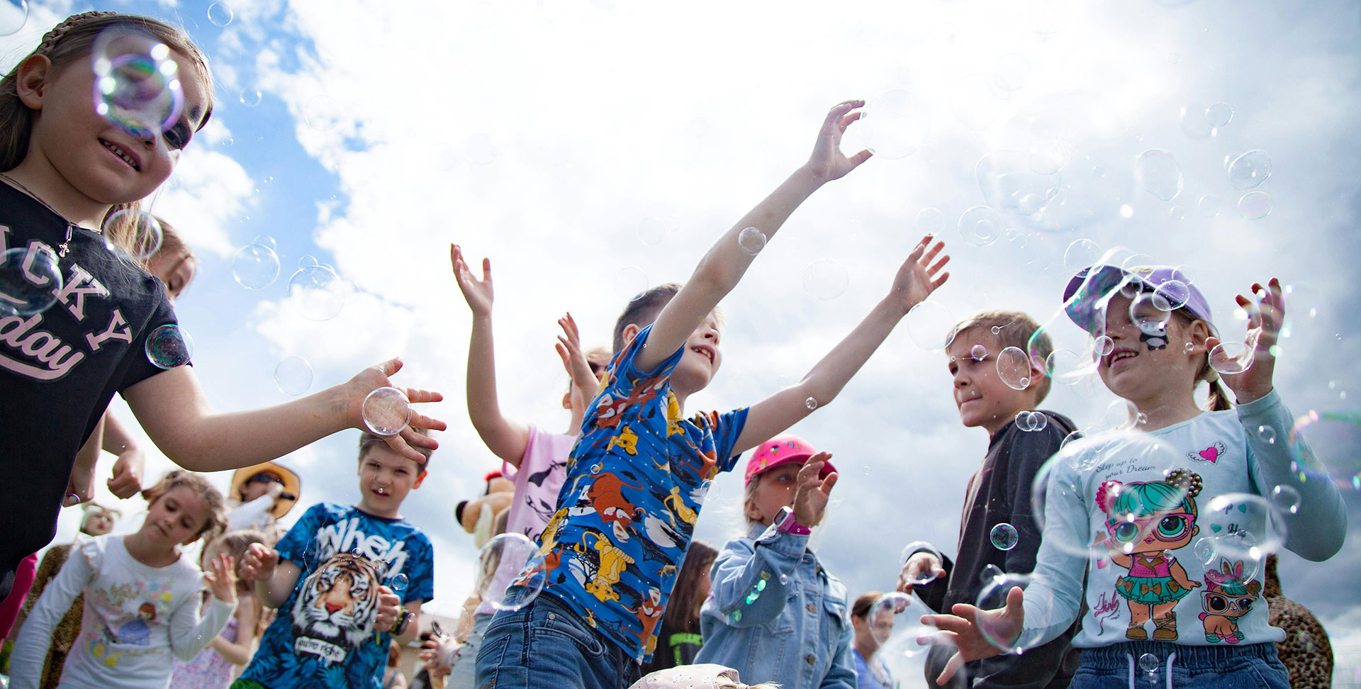 children with bubble machine at a fundraising fun day