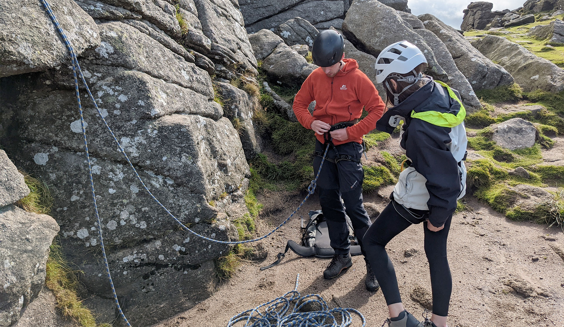 instructor helping fix rock climbing safety gear