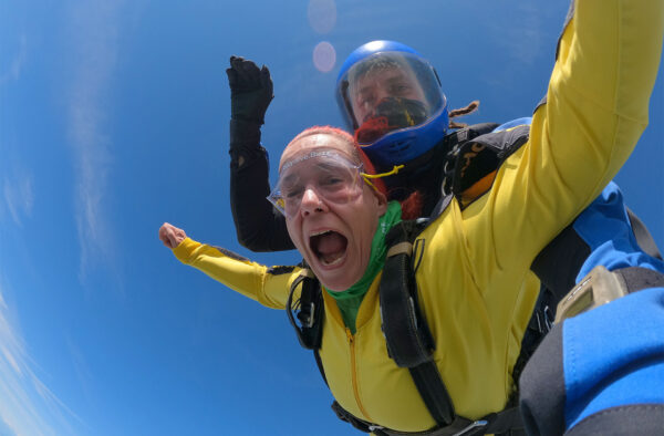 Lady doing tandem skydive with instructor
